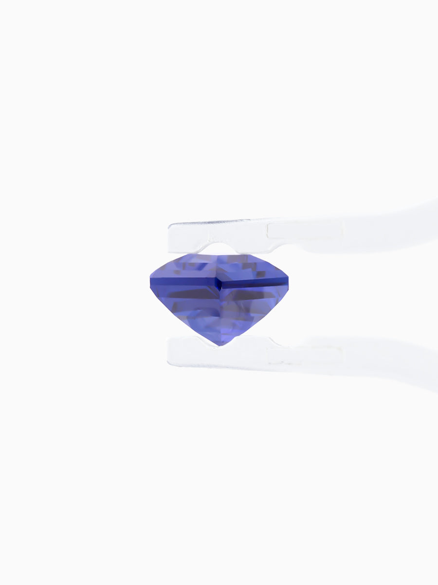 deep royal blue sapphire kite held by tweezers, side view