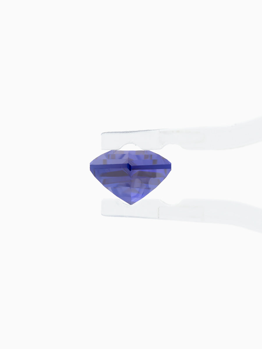 deep royal blue sapphire kite held by tweezers, side view