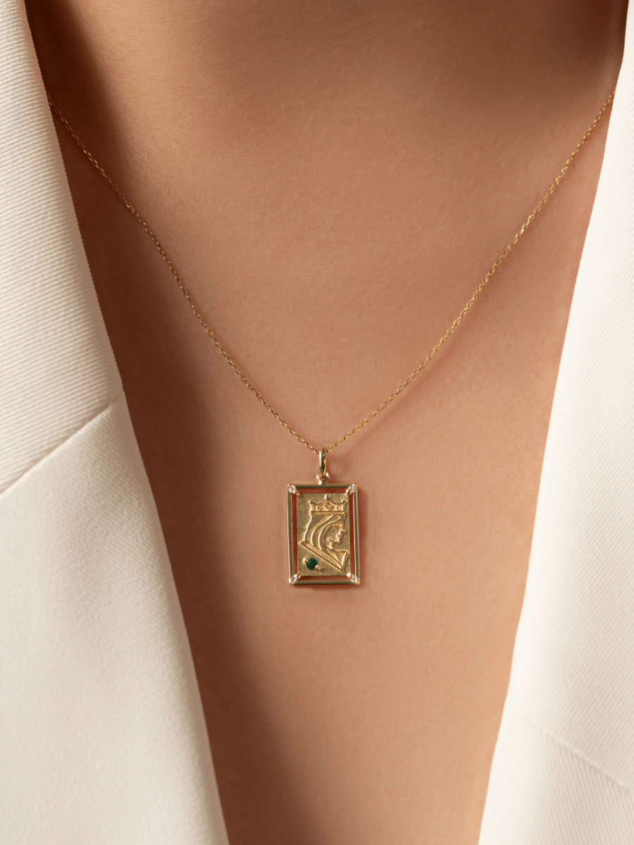 charm with embossed queen illustration on chest