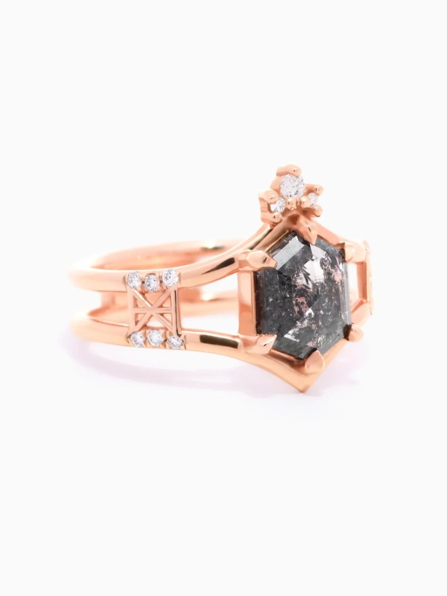 side of contemporary double-banded chevron engagement ring with hexagon center, round melee trefoil, and Art Deco lattice