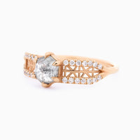 3/4 view of contemporary architectural engagement ring with split shank, lattice detail, pave melee diamonds, and claw-pronged hexagon salt pepper diamond