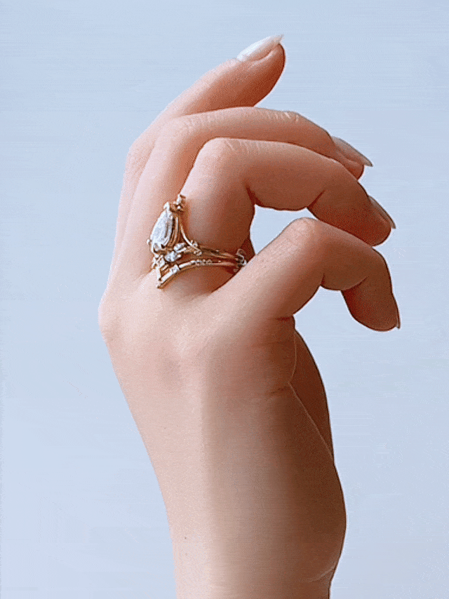 GIF of hand wearing Art Nouveau split shank engagement ring with marquise diamond and chevron band