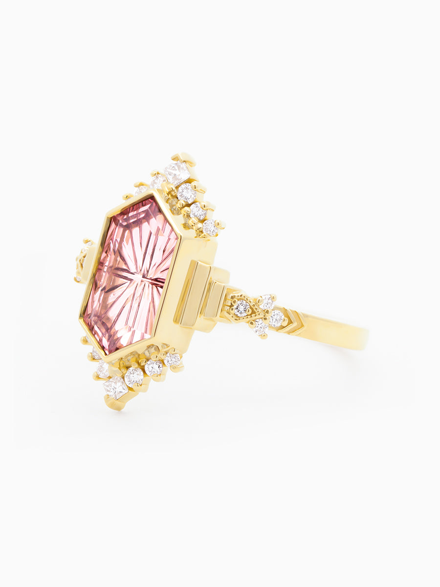 Gold neo-deco ring with a pink gemstone, semi-halo, and sculptural details on a white background. Side View