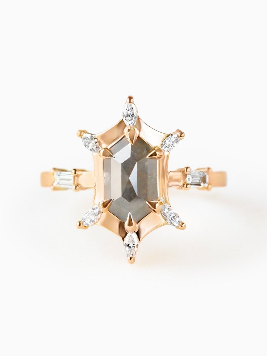 A hexagon-shaped engagement ring with salt and pepper diamonds surrounded by six marquise diamonds at each corner, with two baguettes on the sides.