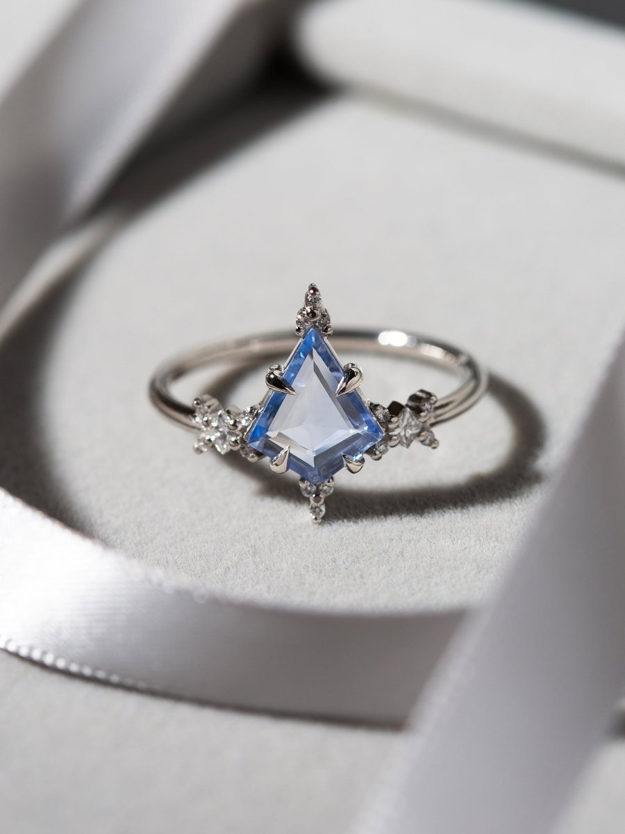 Silver ring with a blue gemstone on a white background