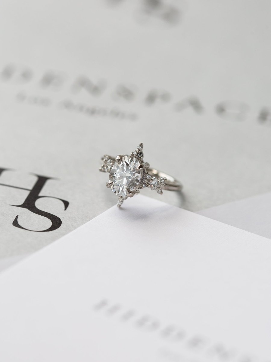 Diamond ring on a white surface with a blurred background