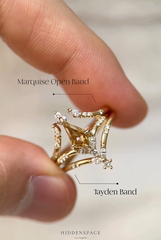 Callie ring styled between a Marquise Open Band and a Jayden Band, held between fingertips