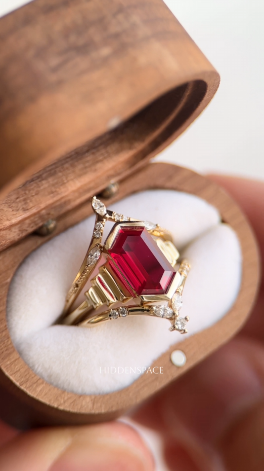 Valentra ruby ring with surrounding bands in an open wooden ring box