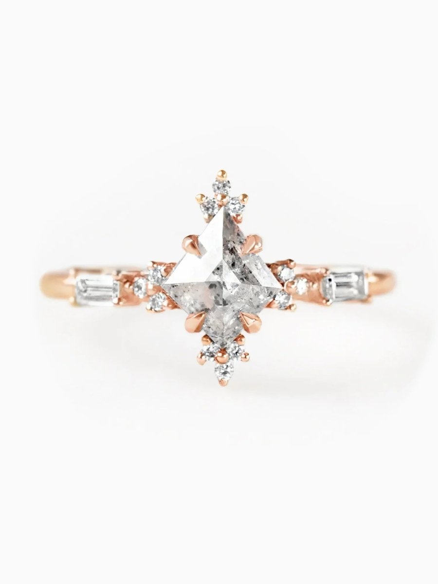 Rose gold ring with a star-shaped diamond on a white background