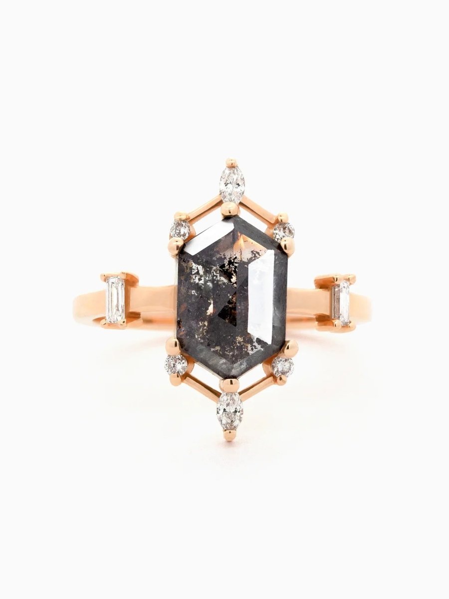 Face view of a contemporary Art Deco ring with hexagon center stone, semi-halo detail, and tapered shoulders