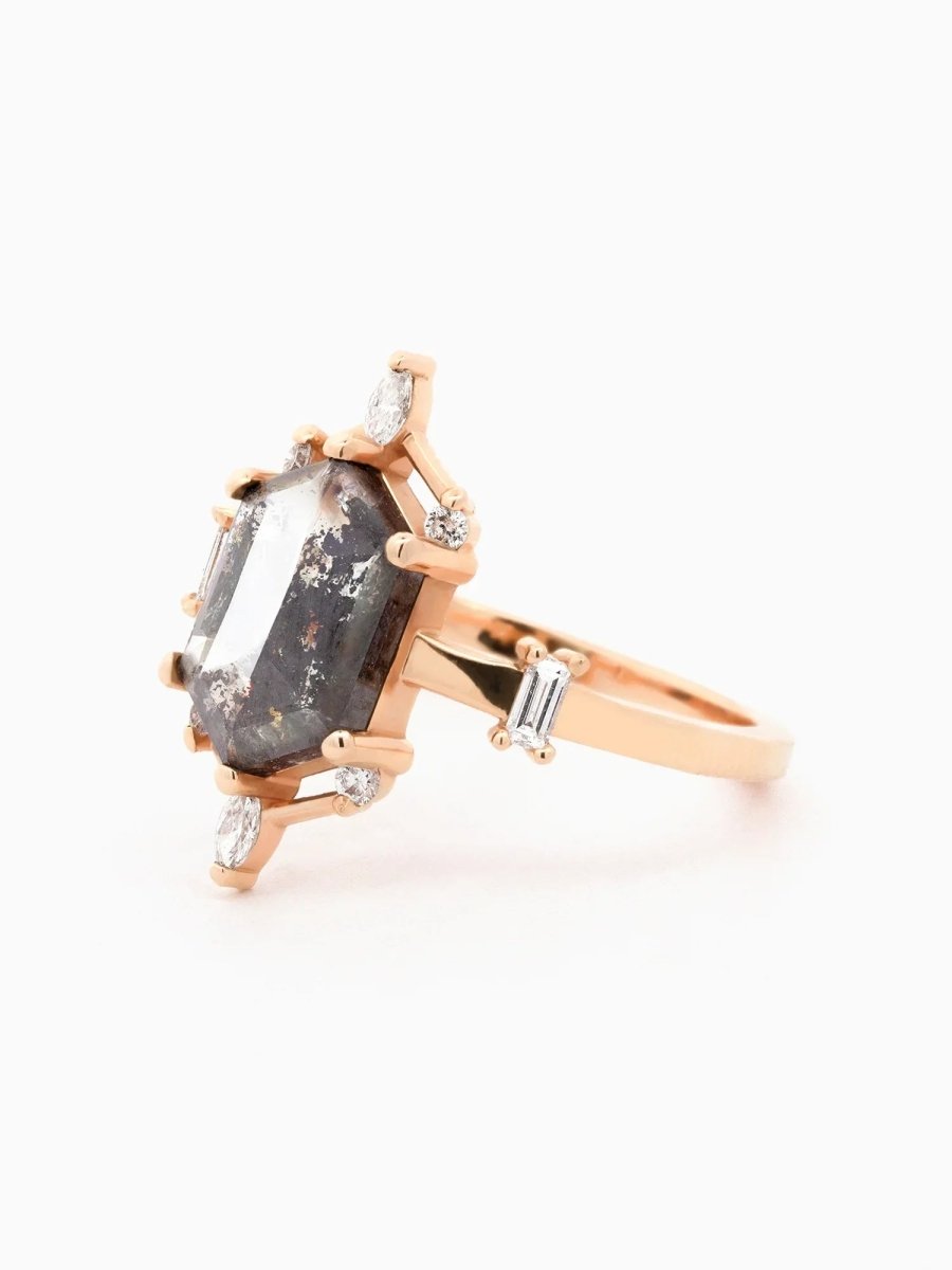 side view of a contemporary Art Deco ring with hexagon center stone, semi-halo detail, and tapered shoulders