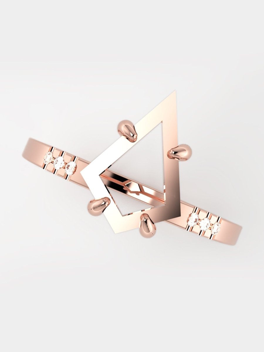 Rose gold geometric bracelet on a light gray background