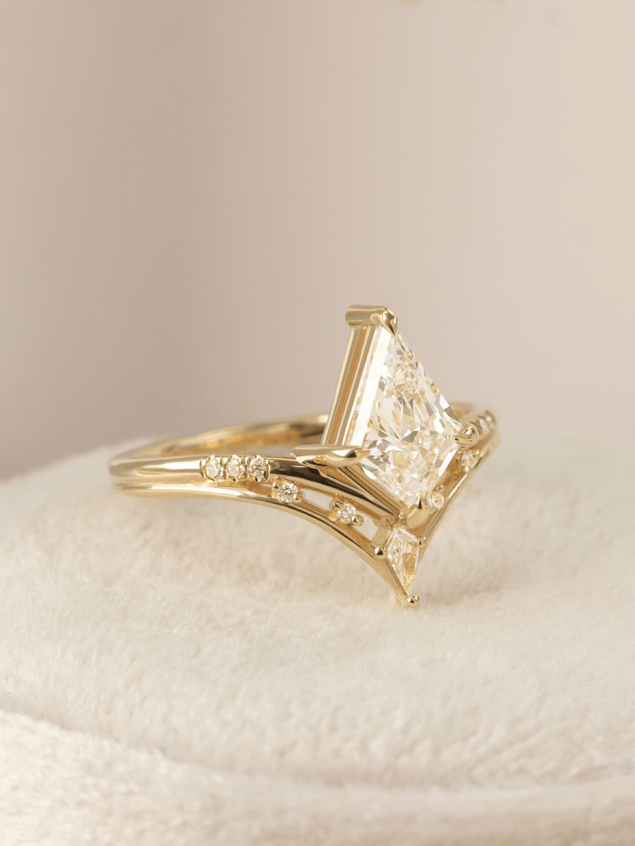 Gold ring with a large diamond on a beige background