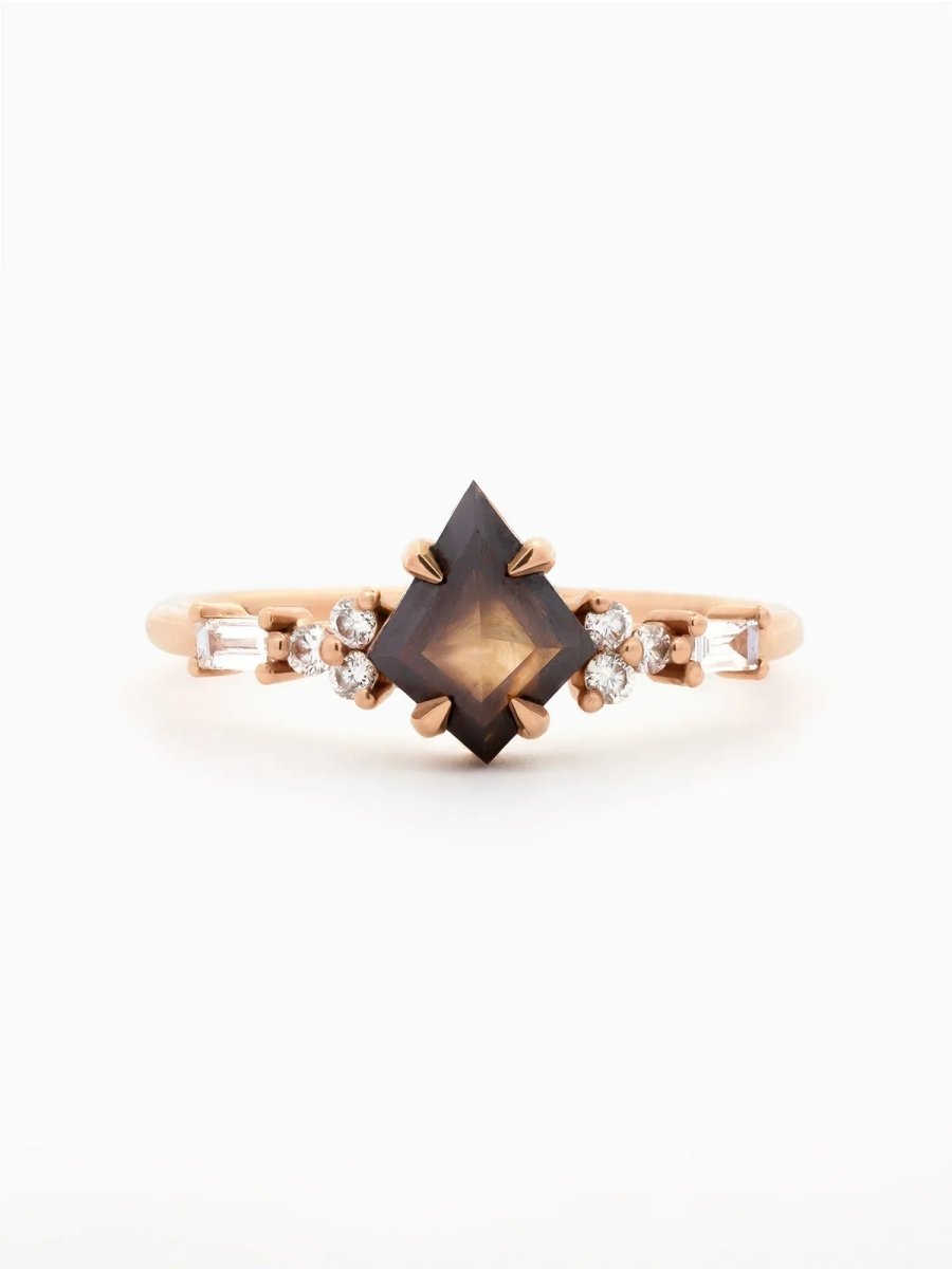 Face view of petite ring with brown kite salt and pepper diamond, trefoil melee accents on shoulders, and baguette stones on band