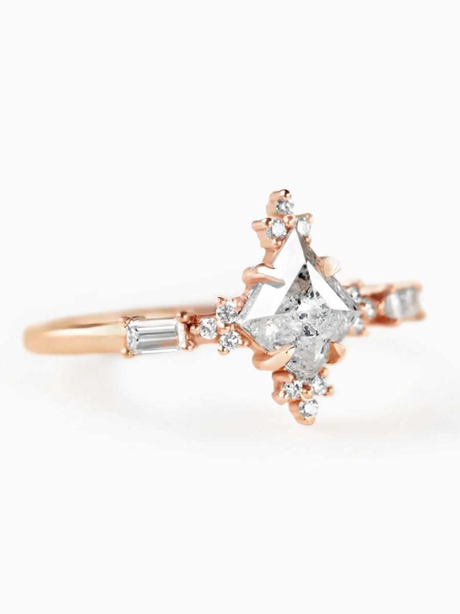 Rose gold ring with diamond accents on a white background