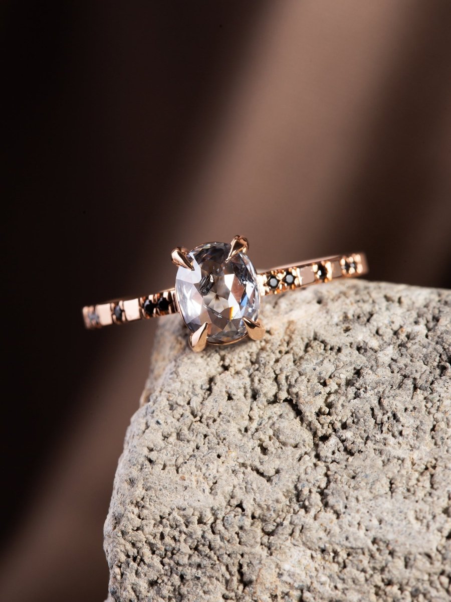 Diamond ring on a textured stone surface with a blurred background