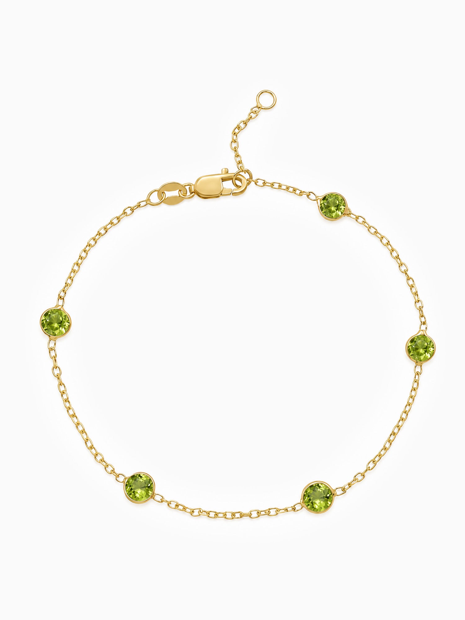 A delicate gold chain bracelet with five evenly spaced round green gemstone accents, displayed on a clean white background.