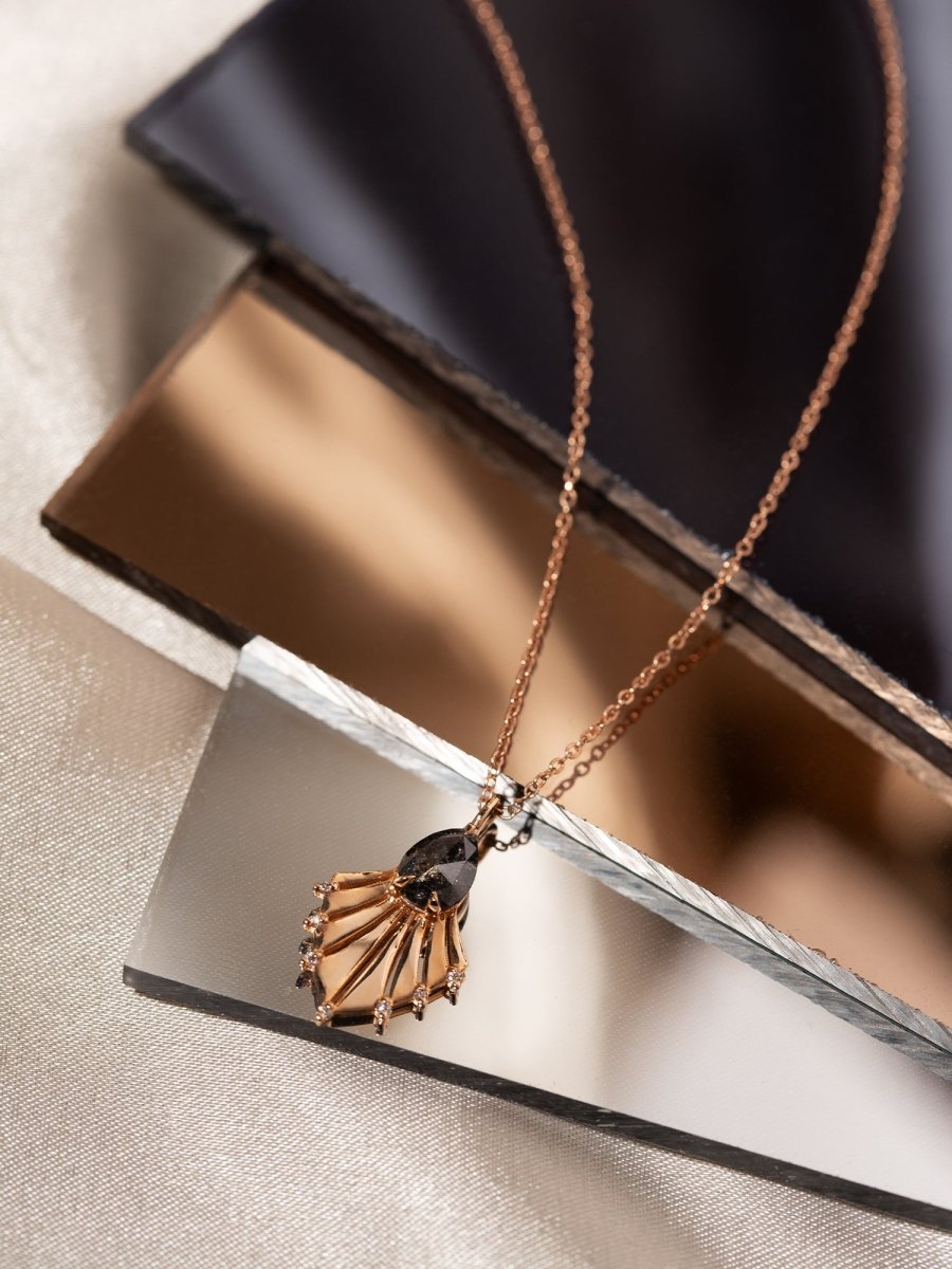 Necklace with a pendant on a reflective surface