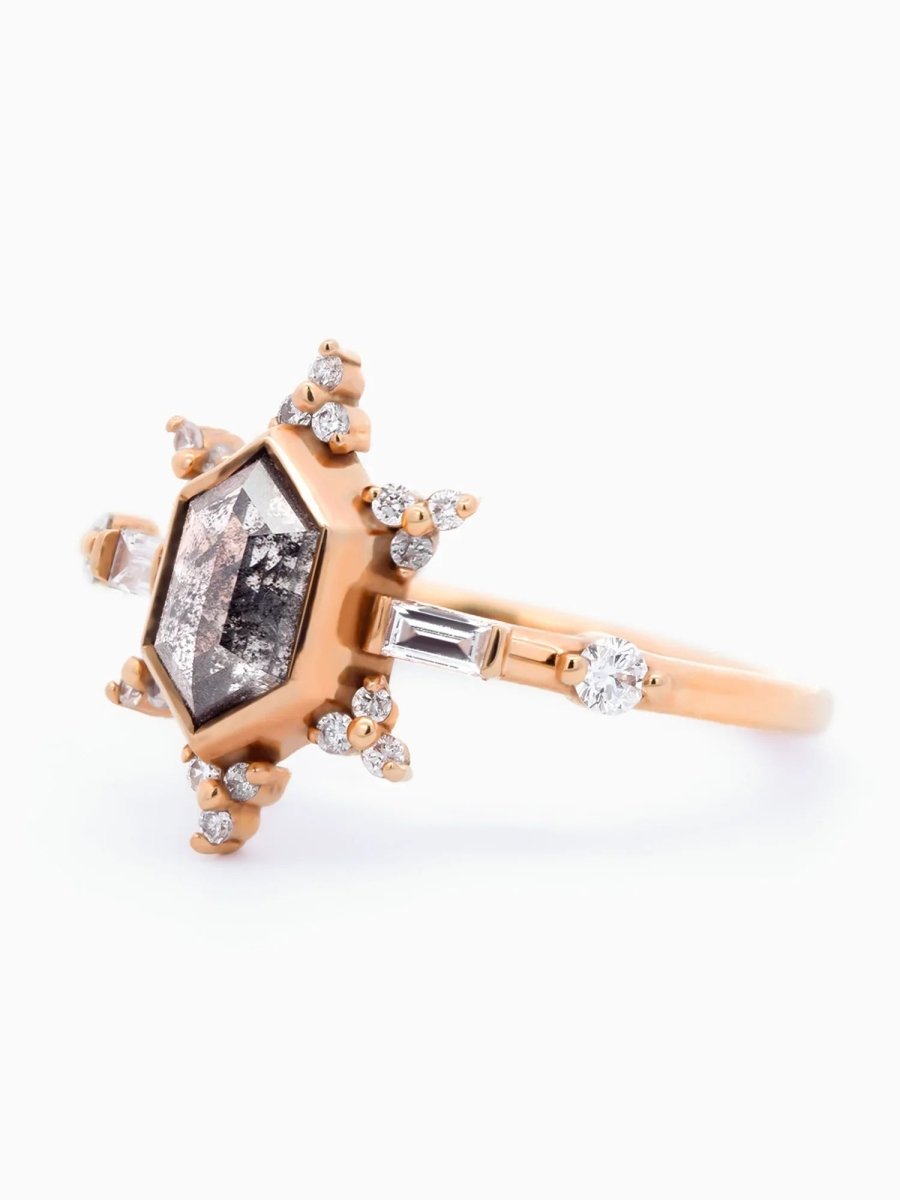 3/4 view of vintage-modern rose gold Art Deco ring with bezel-set salt and pepper hexagon, sunburst halo, and mixed side stones