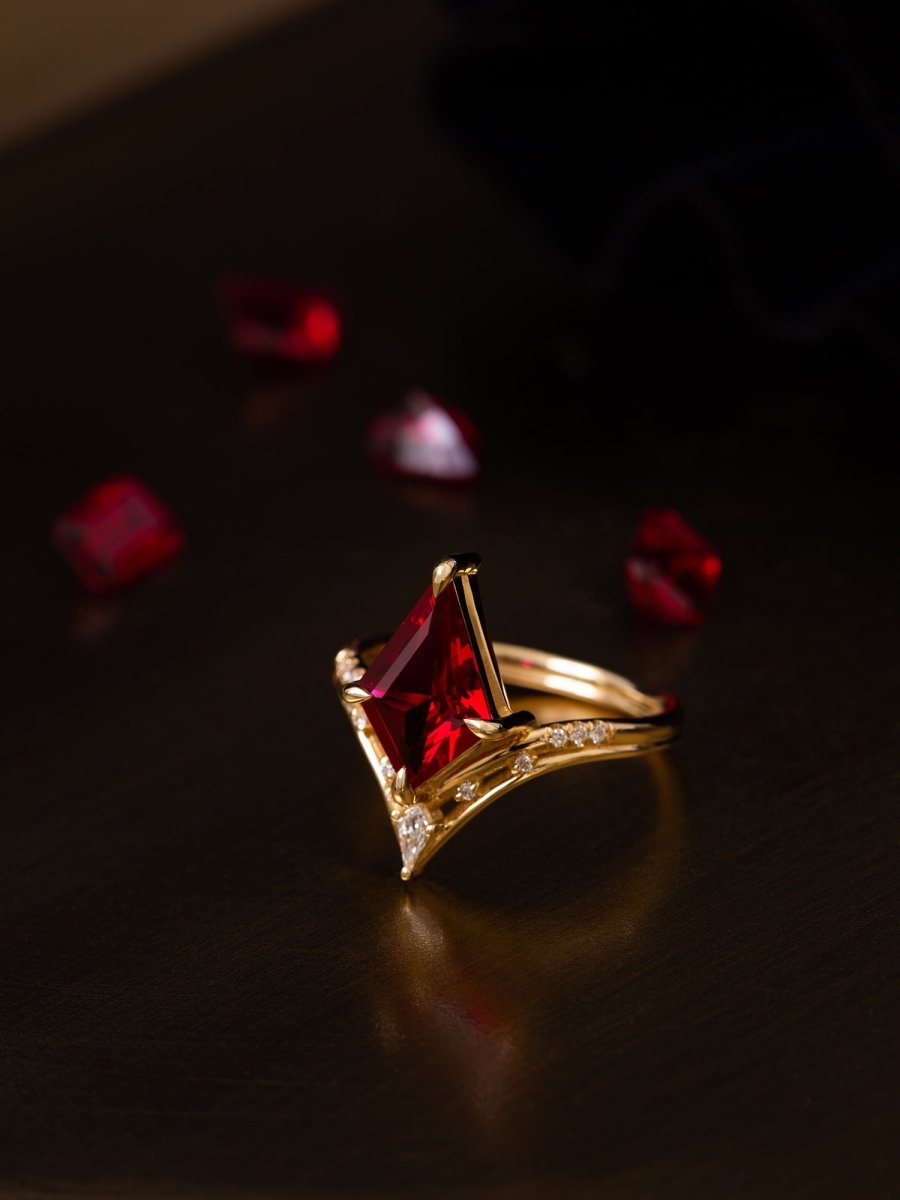 Gold ring with a red gemstone on a dark background