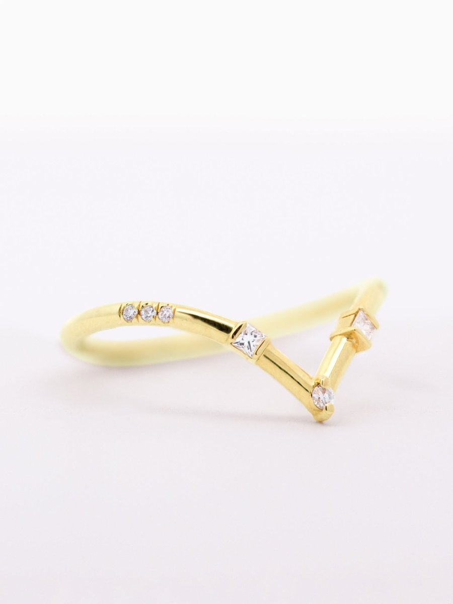 side of Art Deco curved chevron wedding band with round melee diamonds, square accents, and architectural detailing