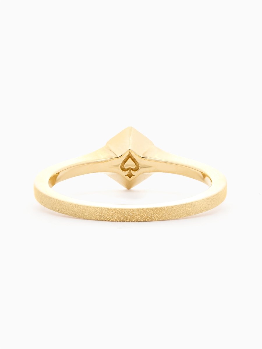 Back view of gold ring revealing hidden engraving beneath the hexagon signet face.