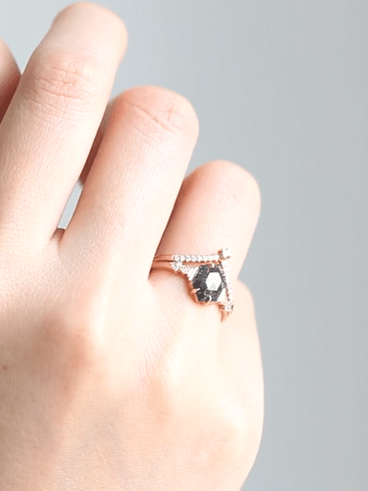 Minimalistic and art deco styled hexagon salt and pepper diamond engagement ring in 14k rose gold with round diamonds.
