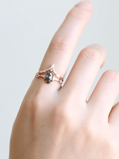 Unique art deco styled hexagon salt and pepper diamond engagement ring in 14k rose gold with smaller round diamonds.