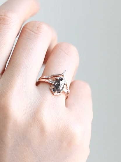 Unique art deco styled hexagon salt and pepper diamond engagement ring in 14k rose gold with baguette and round diamonds.
