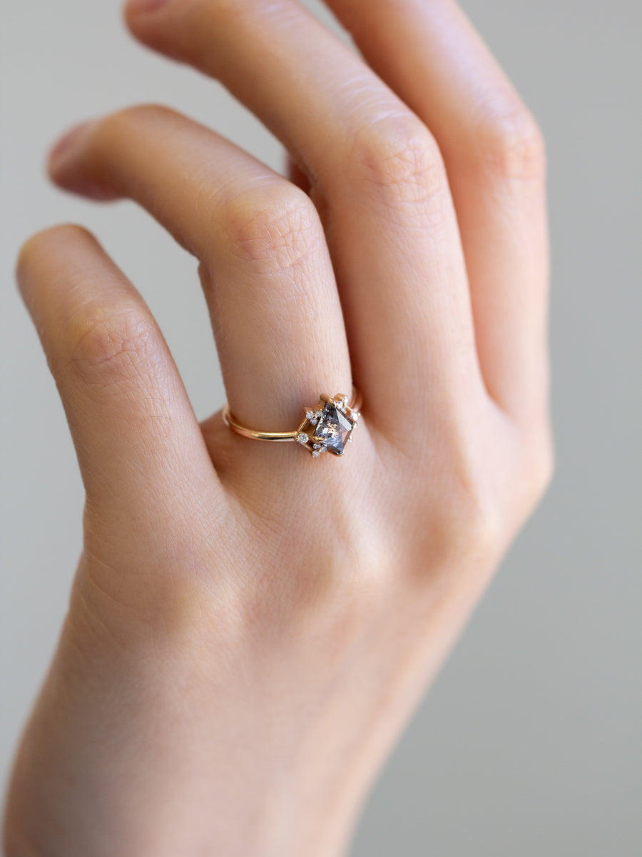 Delicate art deco style kite salt and pepper diamond engagement ring in 14k rose gold with smaller round diamonds.