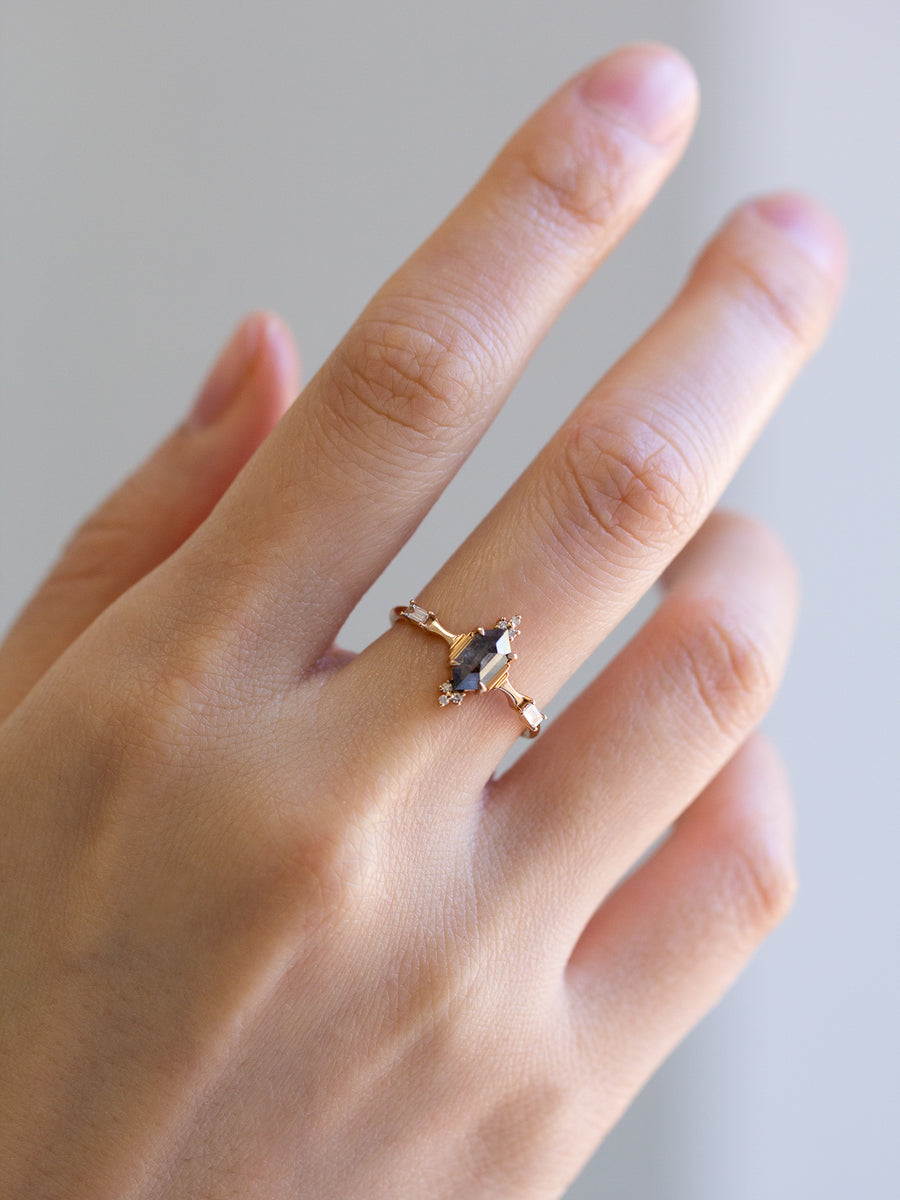 Minimalistic and art deco styled hexagon salt and pepper diamond engagement ring in 14k rose gold with round and baguette diamonds.