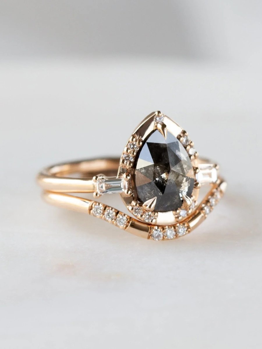 Pear-shaped salt and pepper diamond engagement ring in 14k rose gold with matching band inspired by the art deco style and minimalism.