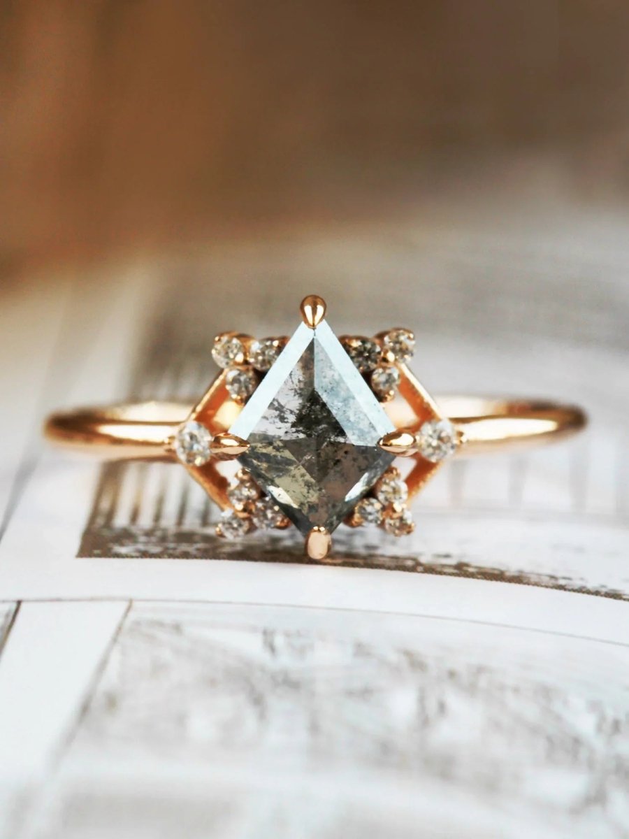 Delicate art deco style kite salt and pepper diamond engagement ring in 14k rose gold with smaller round diamonds.