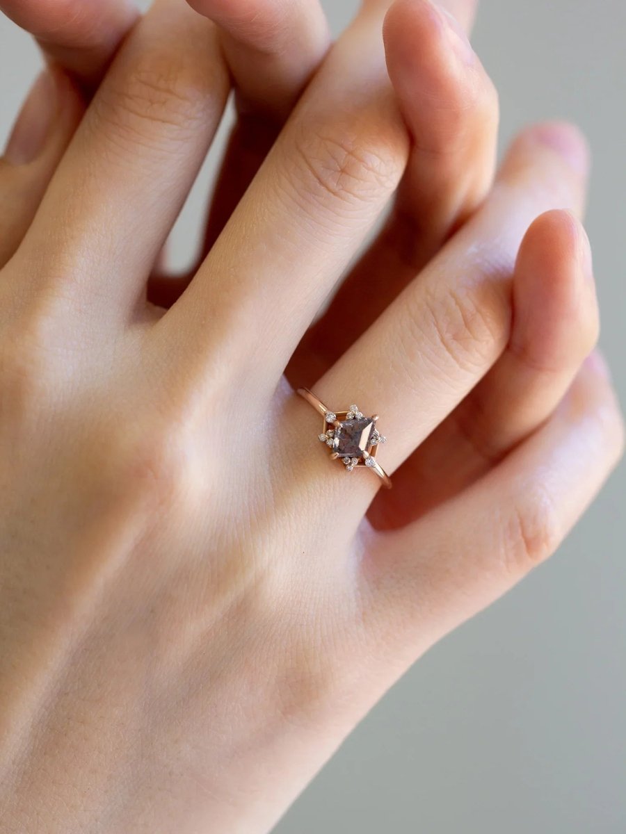 Delicate art deco style kite salt and pepper diamond engagement ring in 14k rose gold with smaller round diamonds.