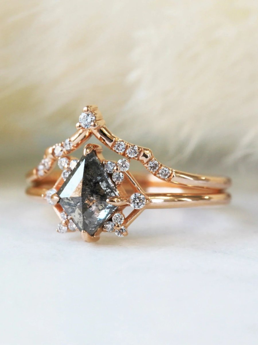 Delicate art deco style kite salt and pepper diamond engagement ring in 14k rose gold with smaller round diamonds.
