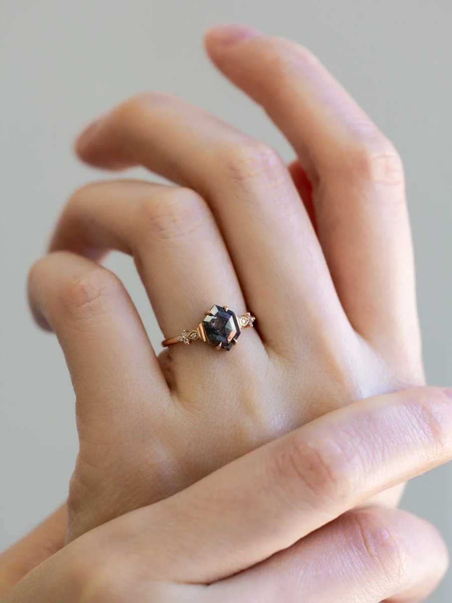 Minimalistic and art deco styled hexagon salt and pepper diamond engagement ring in 14k rose gold with round diamonds.