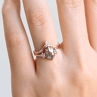 Minimalistic and art deco styled hexagon salt and pepper diamond engagement ring in 14k rose gold with a marquise and round diamonds arranged on each side.