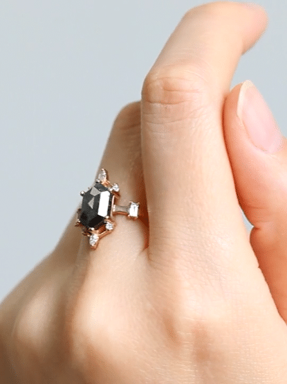 Hexagon salt and pepper diamond engagement ring in 14k rose gold with six smaller marquise and round diamonds inspired by the art deco style and minimalism.