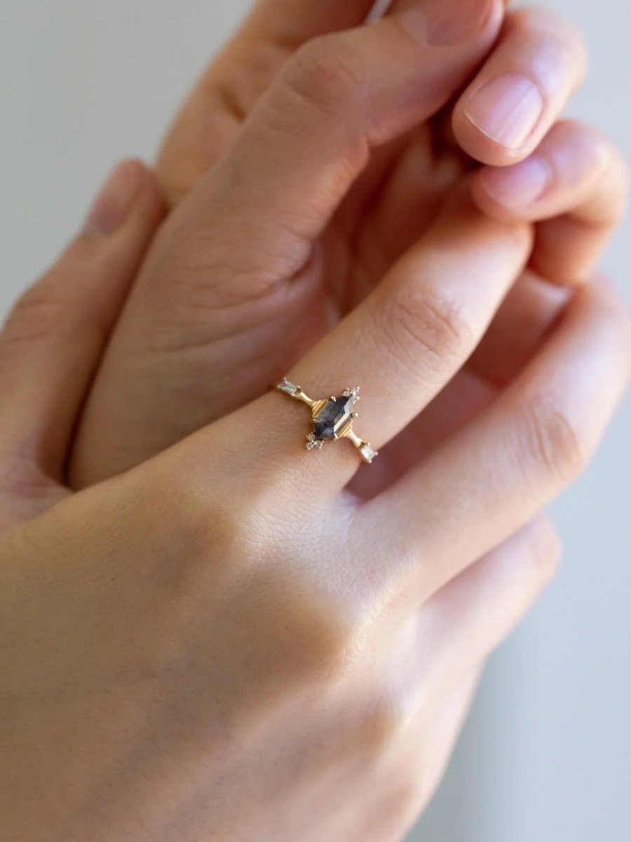 Minimalistic and art deco styled hexagon salt and pepper diamond engagement ring in 14k rose gold with round and baguette diamonds.