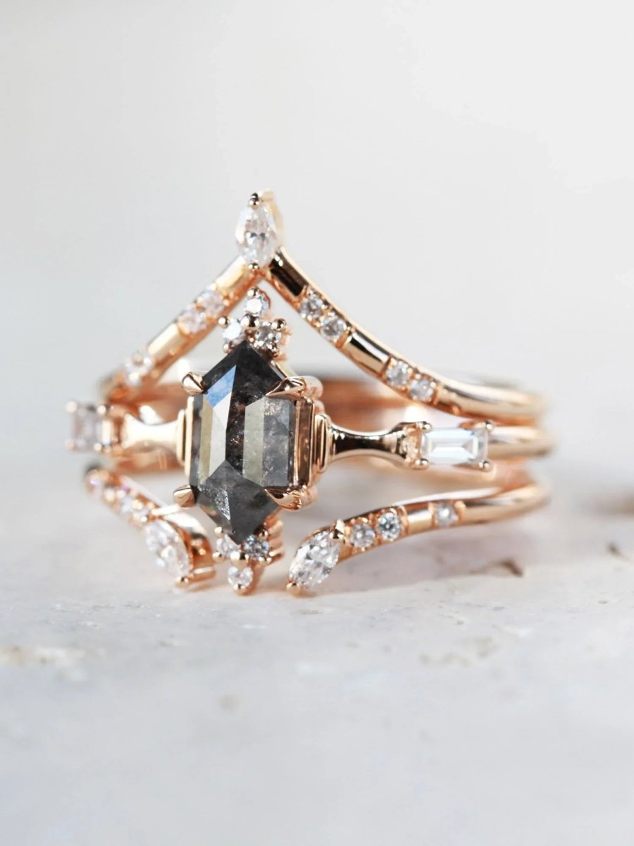 Minimalistic and art deco styled hexagon salt and pepper diamond engagement ring in 14k rose gold with round and baguette diamonds with matching bands.