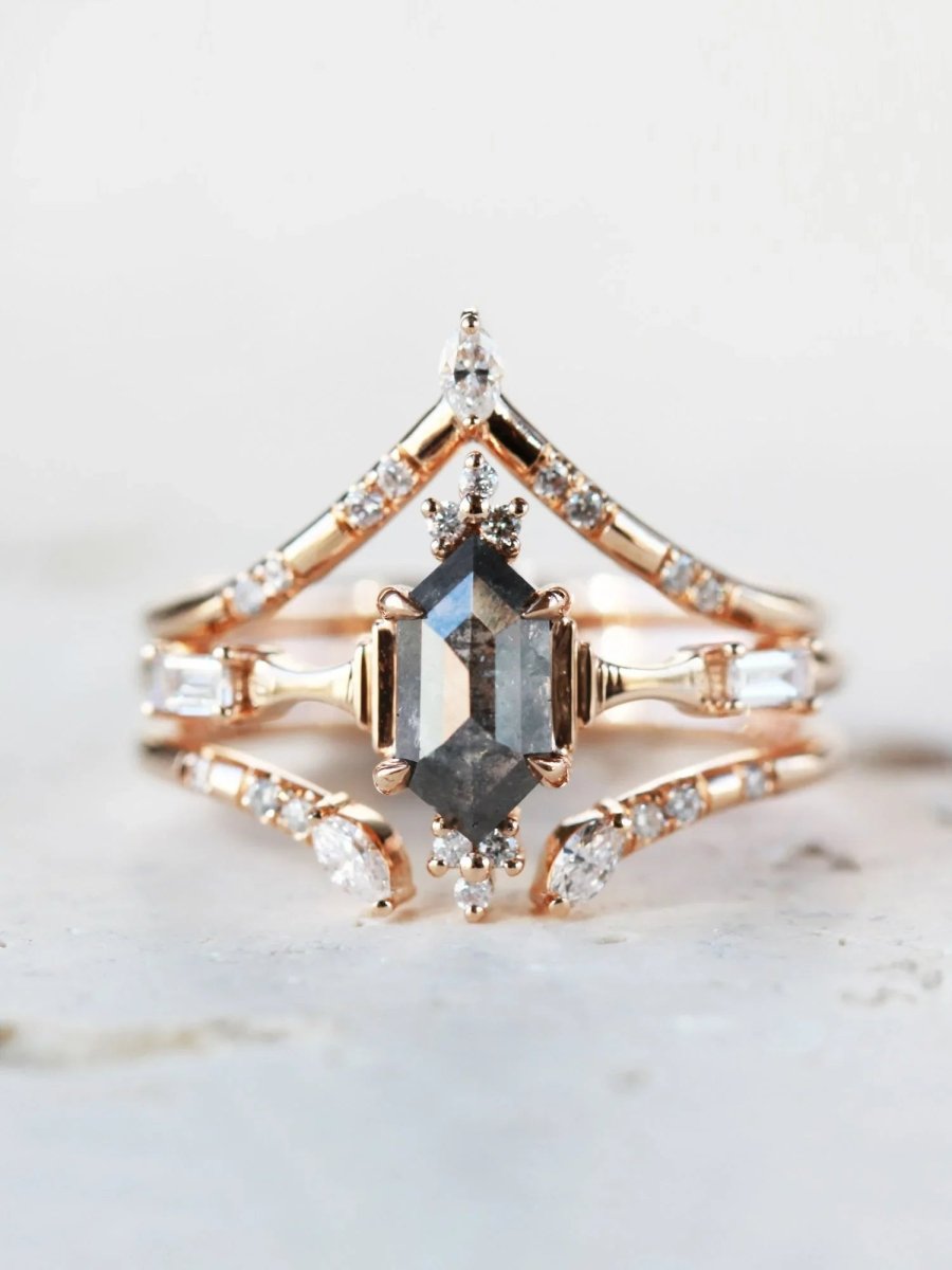 Minimalistic and art deco styled hexagon salt and pepper diamond engagement ring in 14k rose gold with round and baguette diamonds with matching bands.