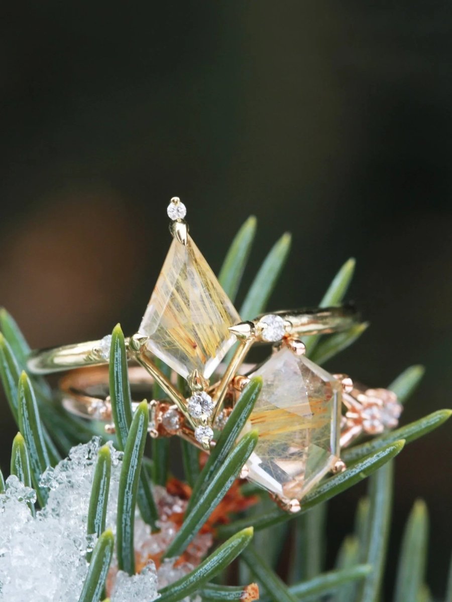 Hexagon rutilated quartz engagement ring in 14k rose gold with smaller baguette and round diamonds inspired by the art deco style and minimalism.
