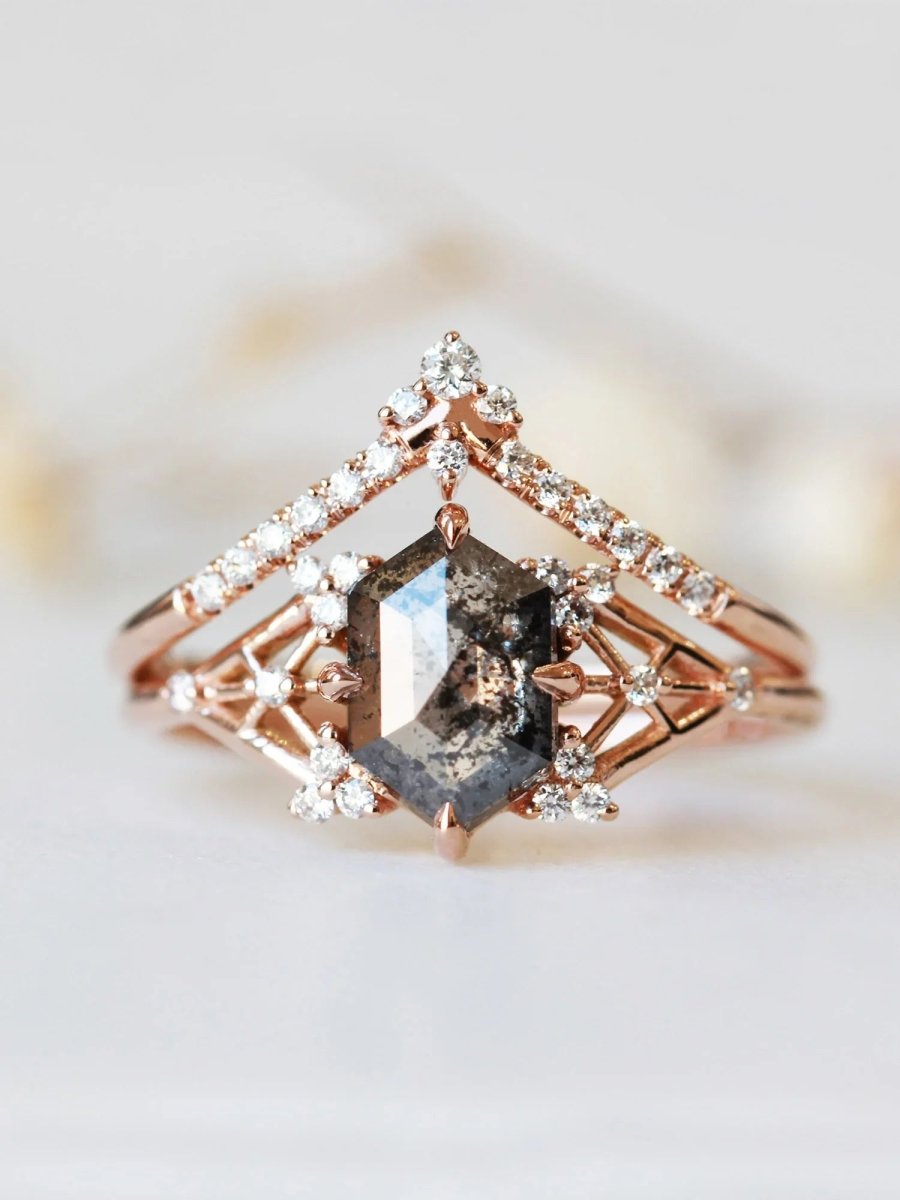 Rose gold ring with a central brown gemstone and diamond accents on a light background