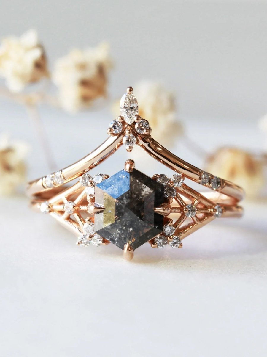 Rose gold ring with a unique diamond design on a light background