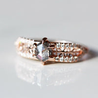 3/4 view of contemporary engagement ring in sunlight, showcasing the brilliance of the salt pepper diamond and sparkle of pave melee