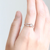 GIF of hand slowly turning, wearing contemporary engagement ring, showcasing the brilliance of the salt pepper diamond and sparkle of the pave