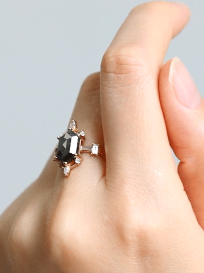 gif of a contemporary Art Deco ring with hexagon center stone, semi-halo detail, on finger