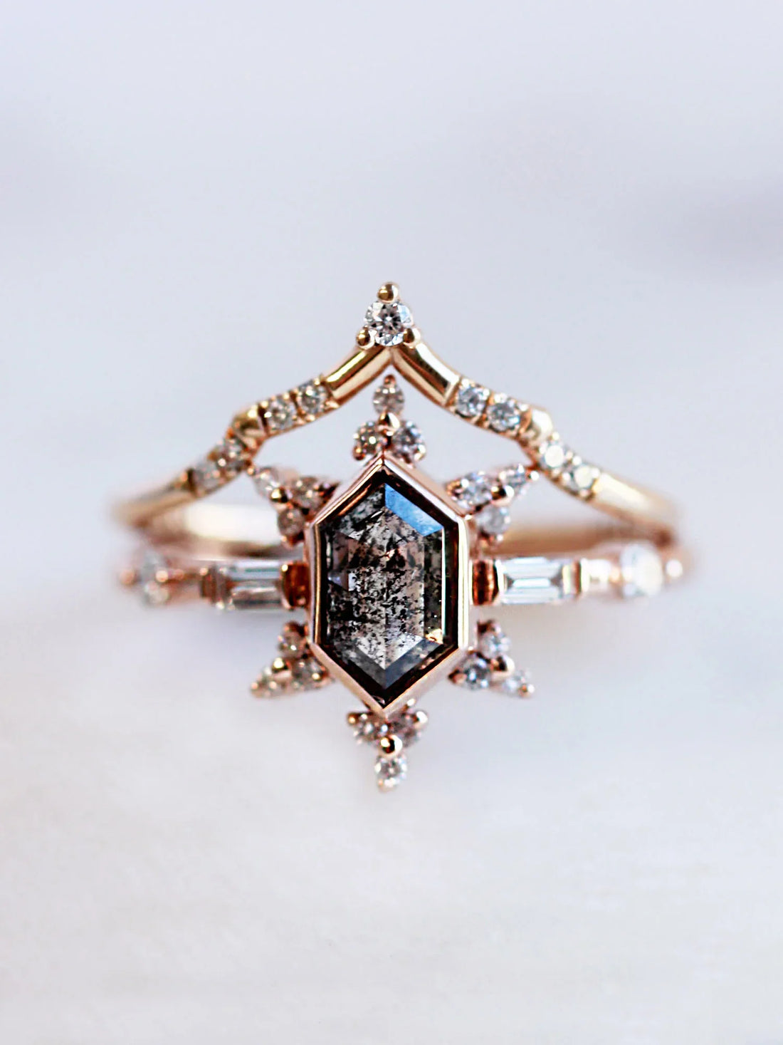 Face view of vintage-modern rose gold Art Deco ring stacked with draped chevron wedding band, highlighting intricate details and design