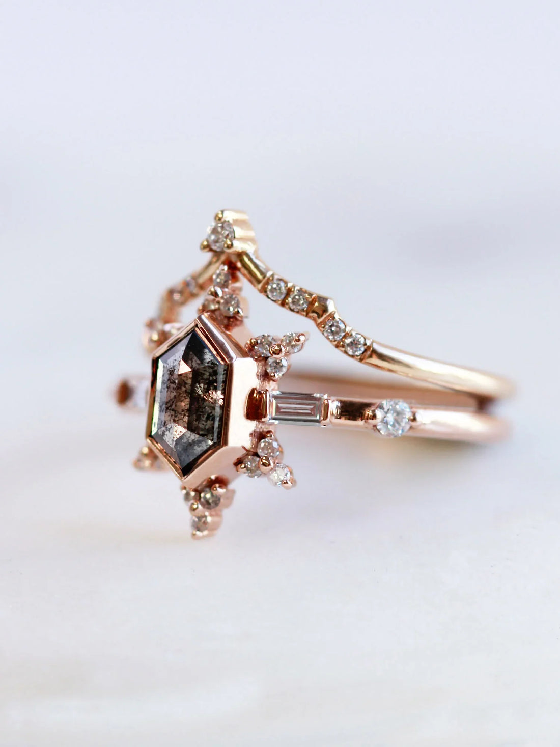 3/4 view of vintage-modern rose gold Art Deco ring stacked with draped chevron wedding band, highlighting intricate details and design