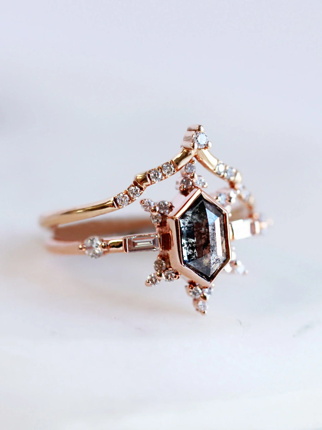 3/4 view of vintage-modern rose gold Art Deco ring stacked with draped chevron wedding band, highlighting their elegant pairing and sparkle